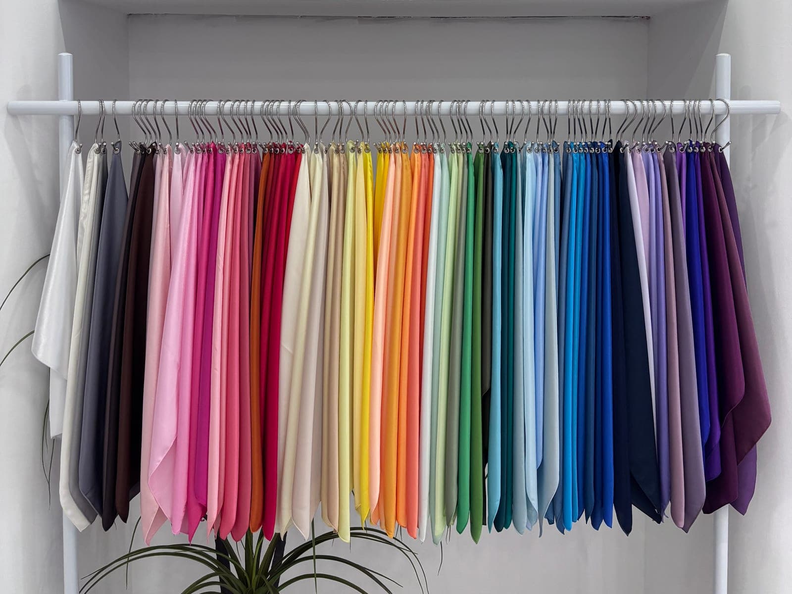 A rack of draping fabrics arranged across the seasonal palettes